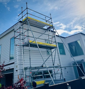 Scaffolding providing safe roof access for a solar panel installation on an Auckland home. | Sidewall Scaffolding