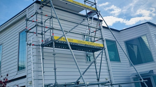 Scaffolding providing safe roof access for a solar panel installation on an Auckland home. | Sidewall Scaffolding